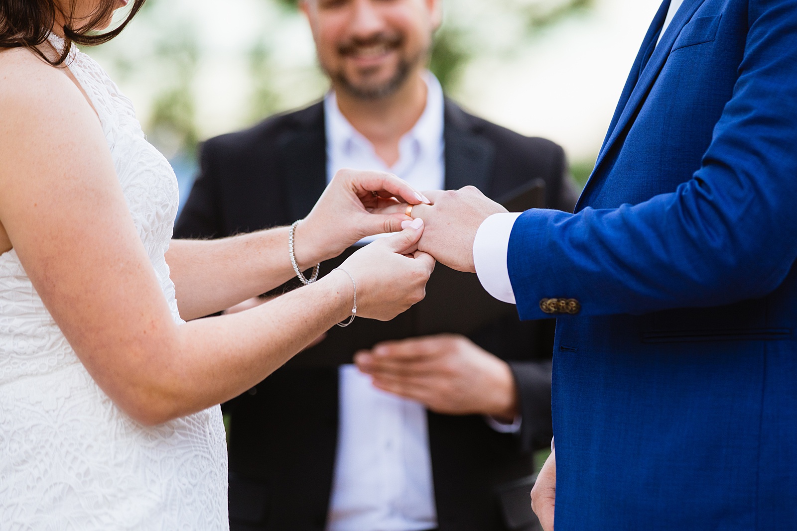 Bride & Groom exchange rings during their wedding ceremony at Mogollon Rim by Arizona elopement photographer Juniper and Co Photography.