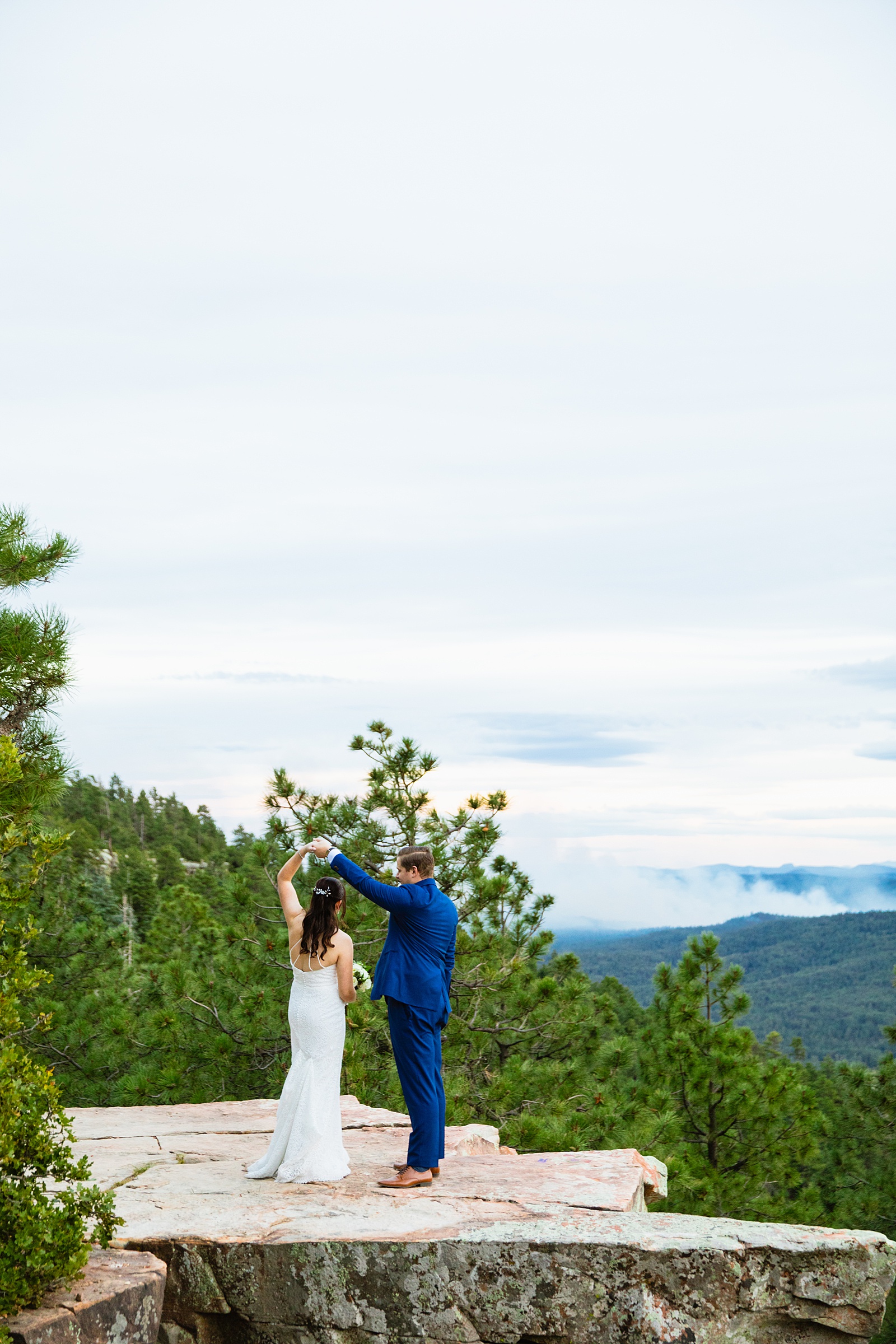 Bride & Groom dancing together during their Mogollon Rim elopement by Arizona elopement photographer Juniper and Co Photography.