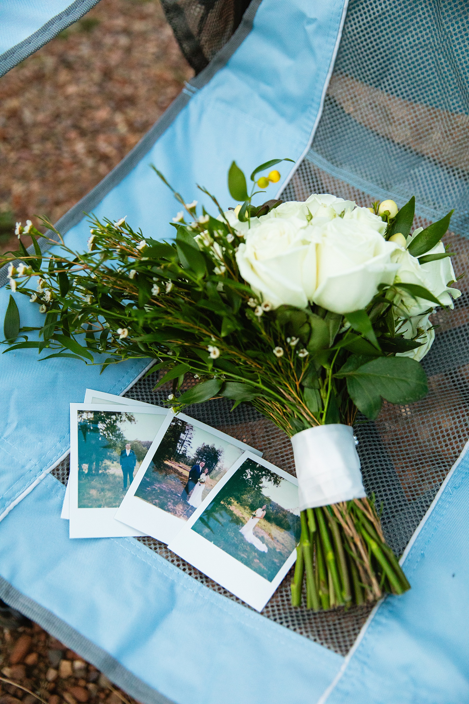 Brides's wedding day details of polaroid photos and bouquet by Juniper and Co Photography.