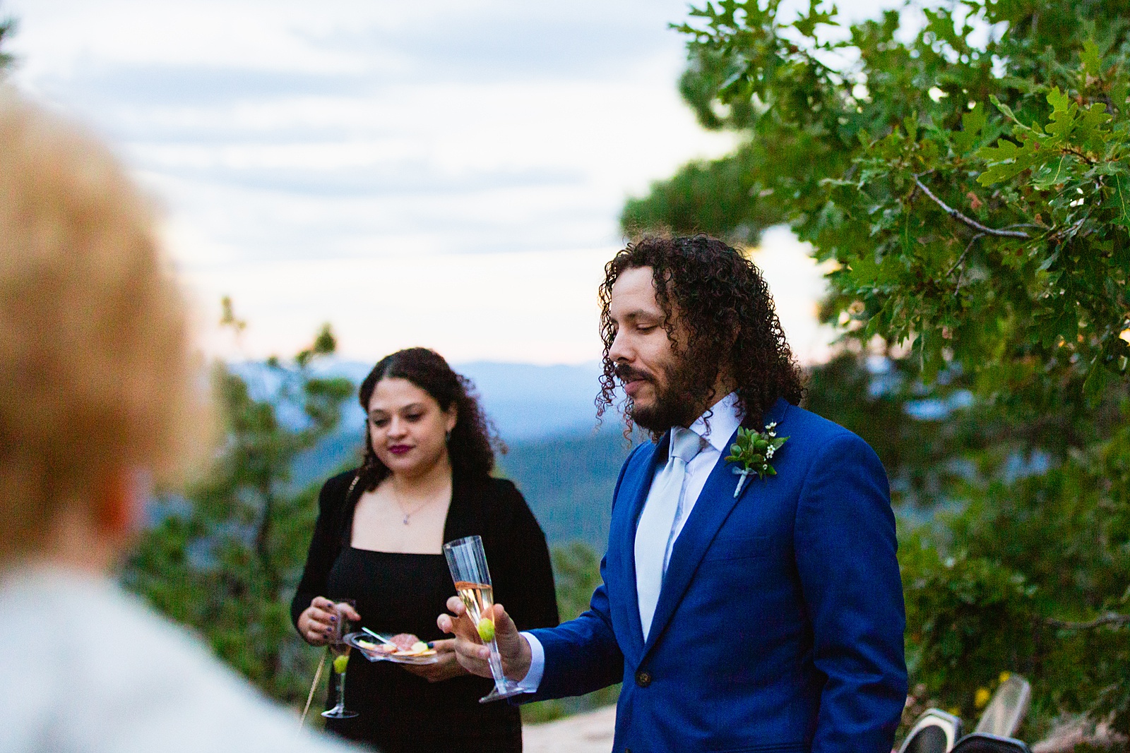 Best man shares a toast at Mogollon Rim wedding reception by Arizona elopement photographer Juniper and Co Photography.