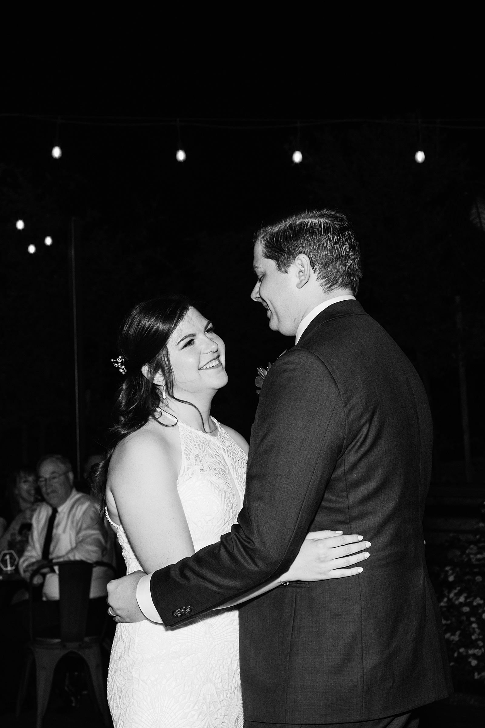 Bride & Groom sharing first dance at their San Tan Gardens wedding reception by Arizona wedding photographer Juniper and Co Photography.