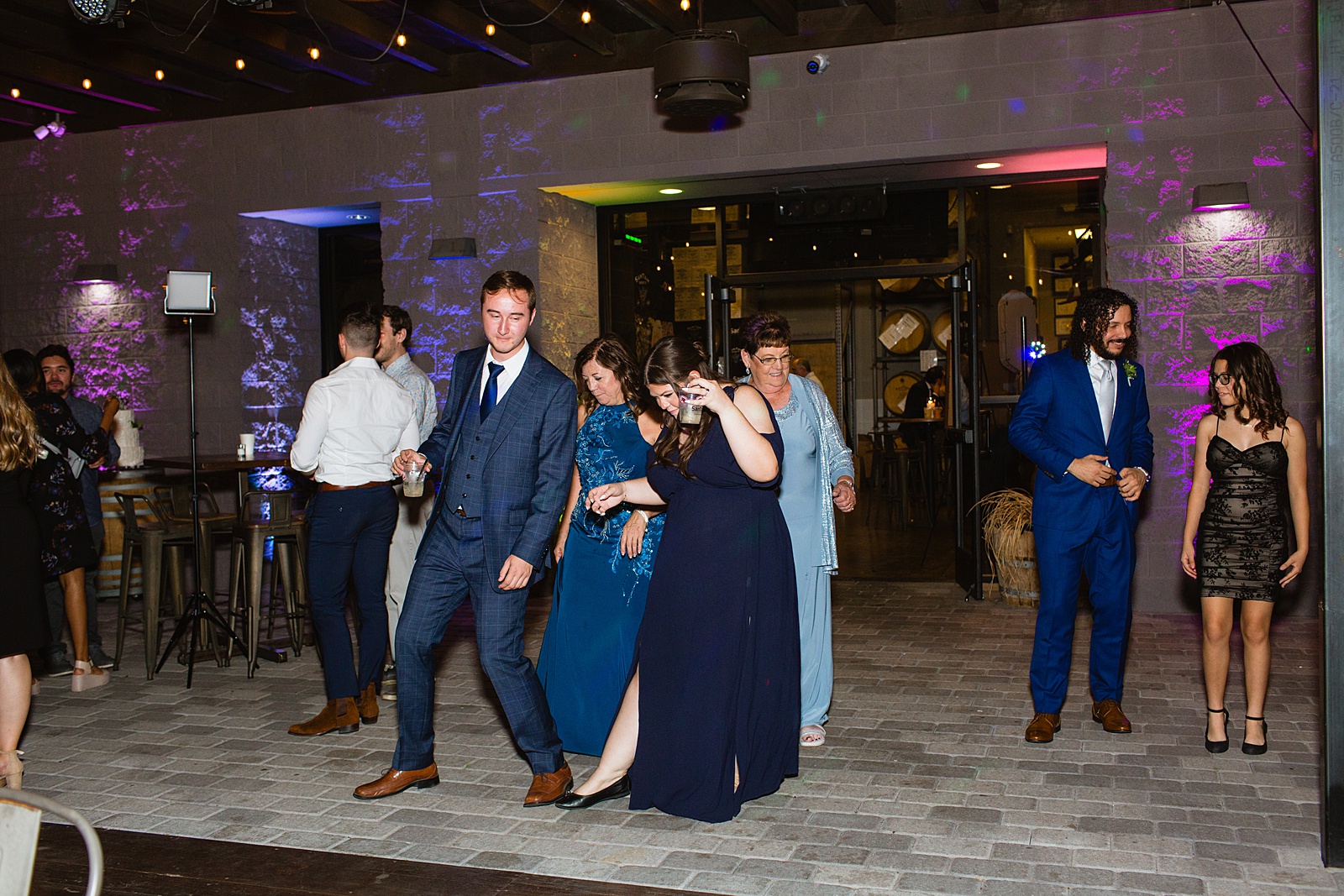 Guests dancing together at San Tan Gardens wedding reception by Arizona wedding photographer Juniper and Co Photography