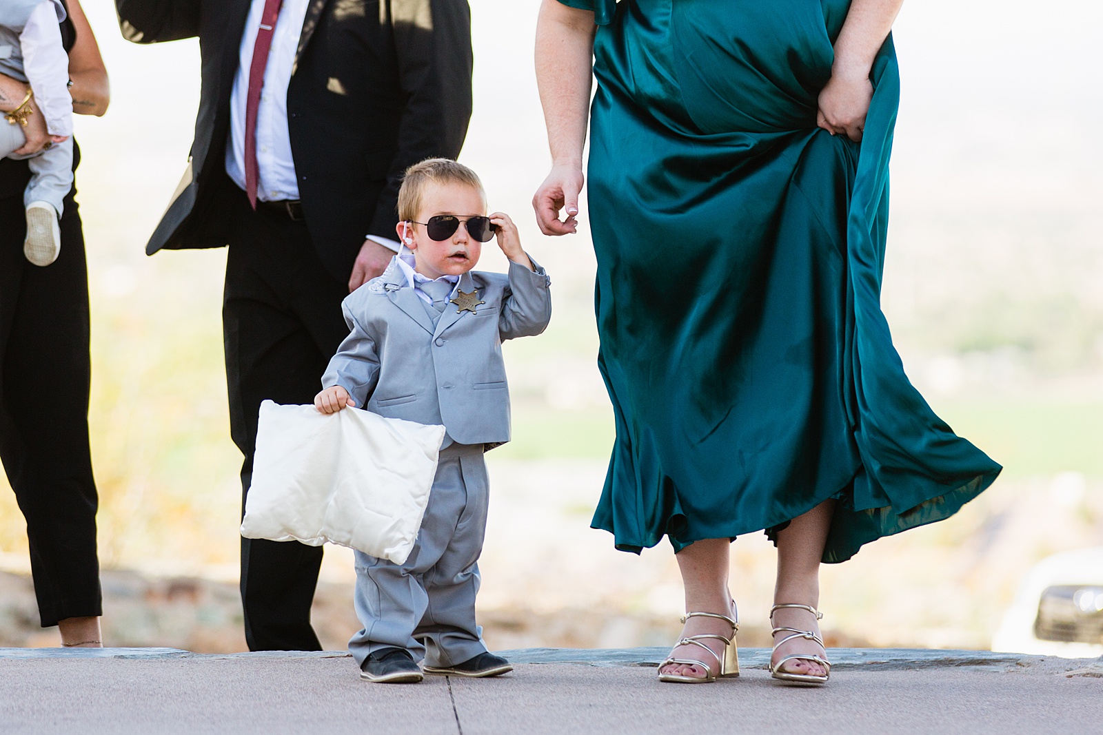 Ring bearer walking down aisle during intimate desert wedding ceremony by Phoenix wedding photographer Juniper and Co Photography.
