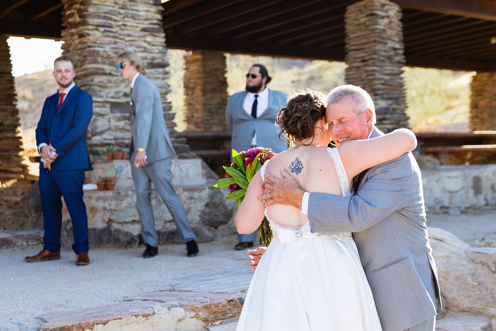 Bride walking down aisle during intimate desert wedding ceremony by Phoenix wedding photographer Juniper and Co Photography.
