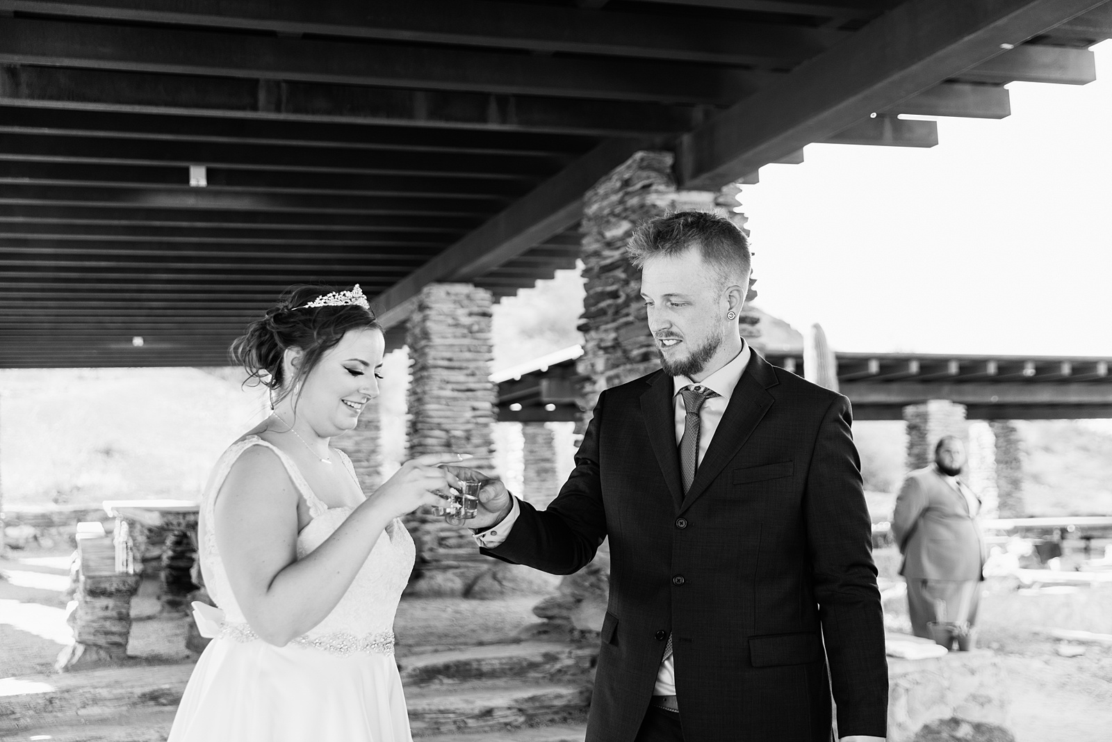 Bride and groom share tequila shots during their intimate desert wedding ceremony by Phoenix wedding photographer Juniper and Co Photography.