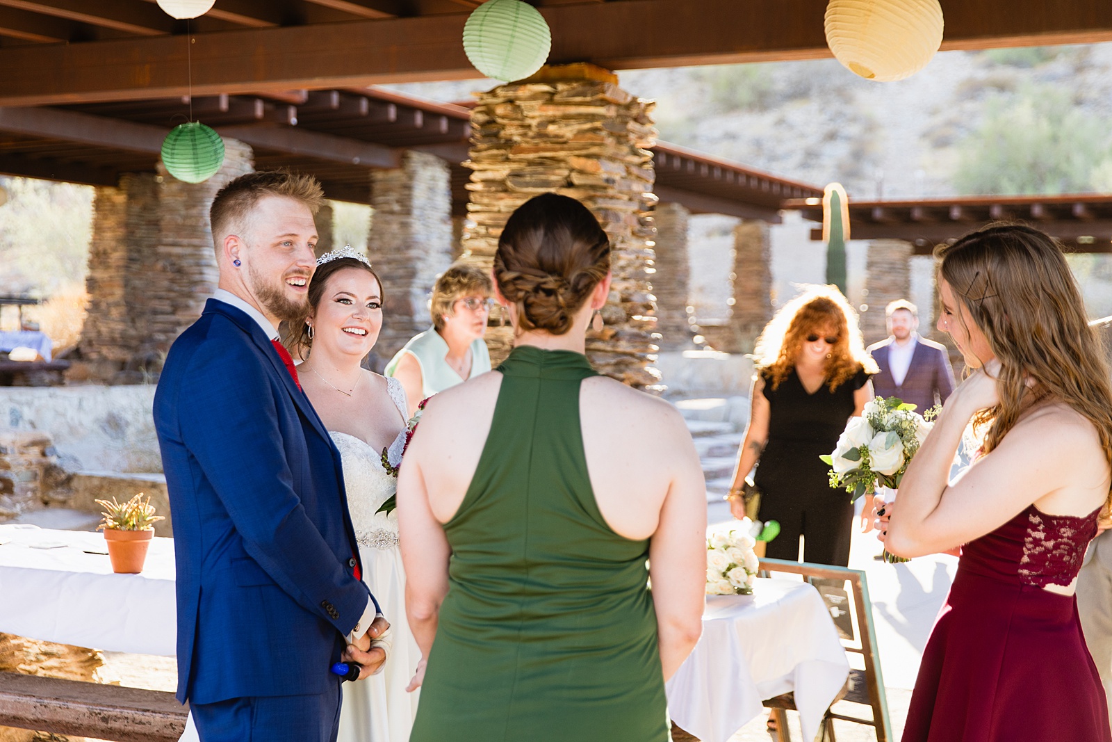 Bride and groom with guests at intimate desert wedding reception by Phoenix wedding photographer Juniper and Co Photography.