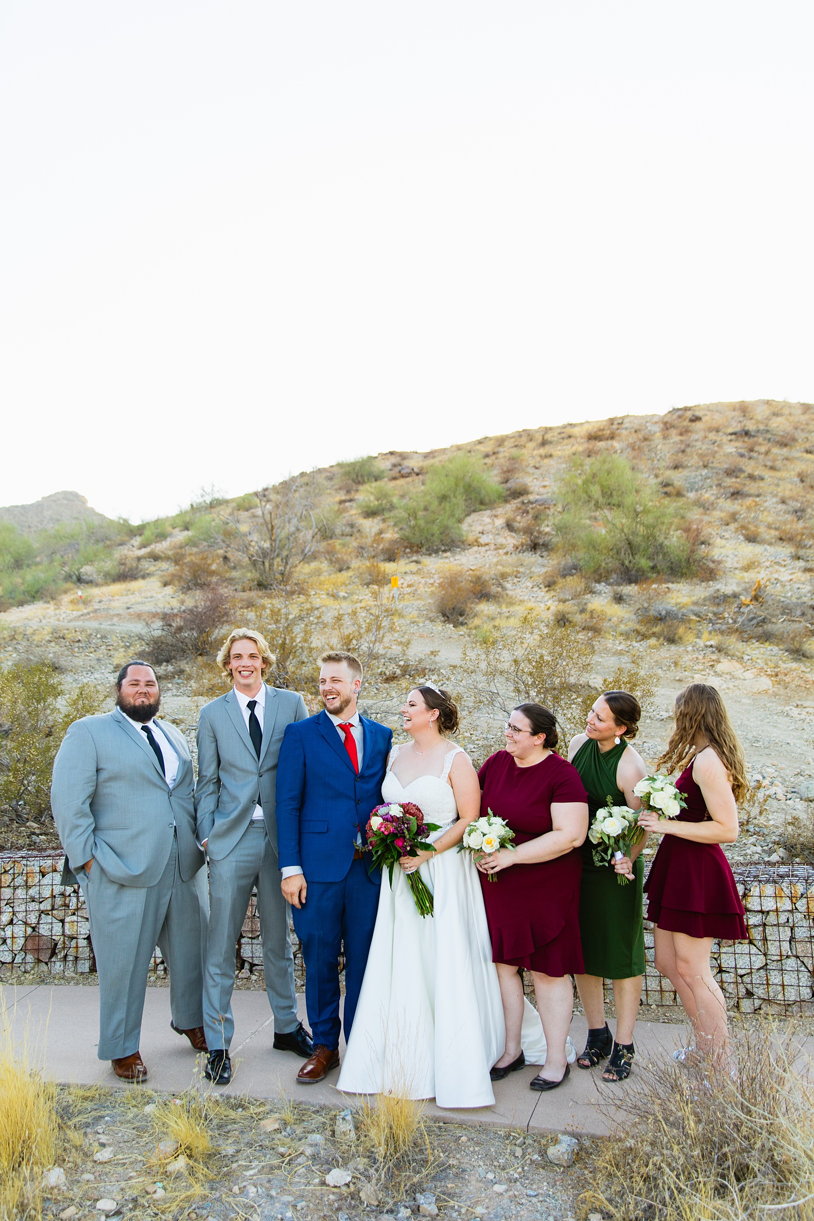 Bridal party laughing together at intimate desert wedding by Phoenix wedding photographer Juniper and Co Photography.