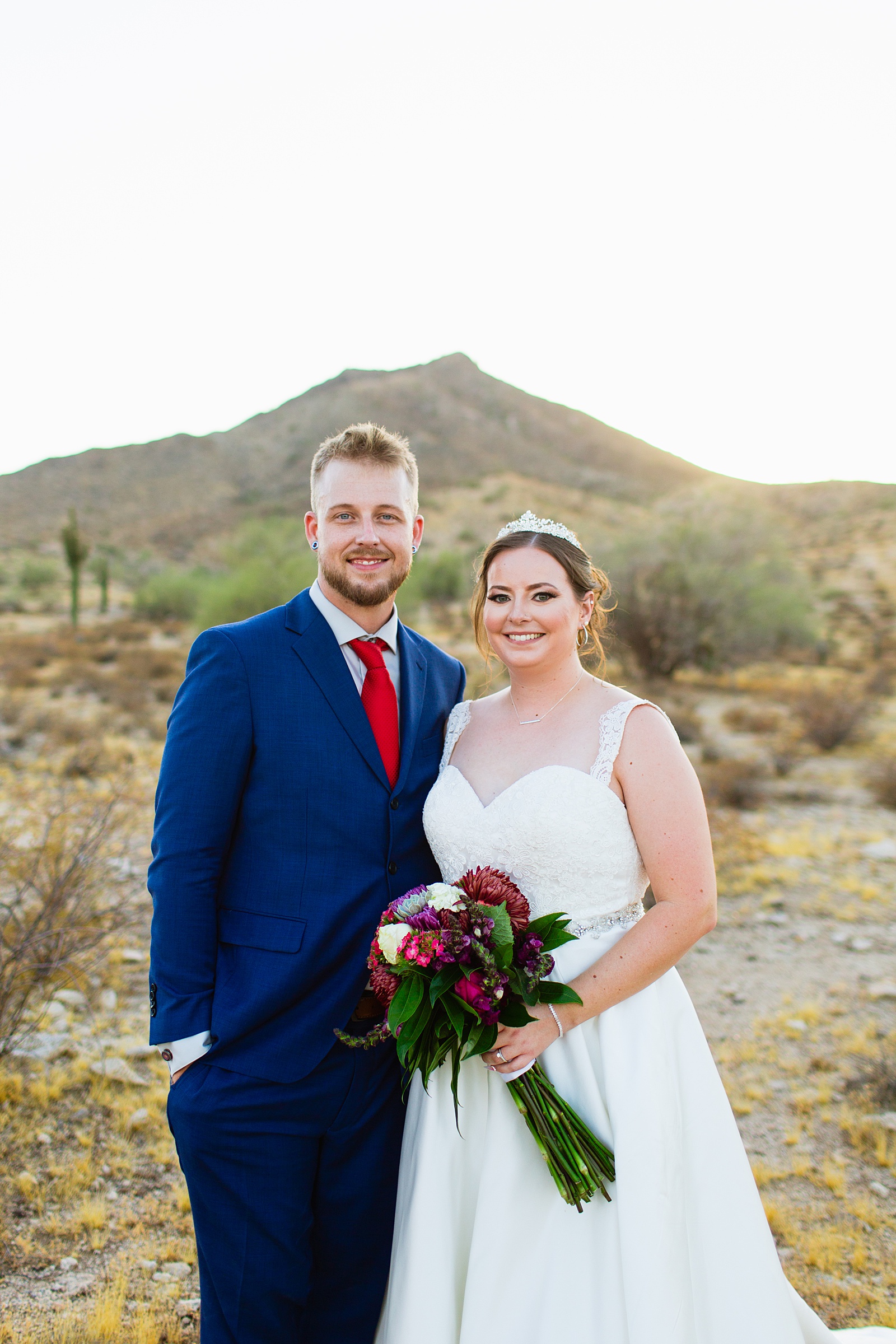 Bride and groom pose for their intimate desert wedding by Phoenix wedding photographer Juniper and Co Photography.