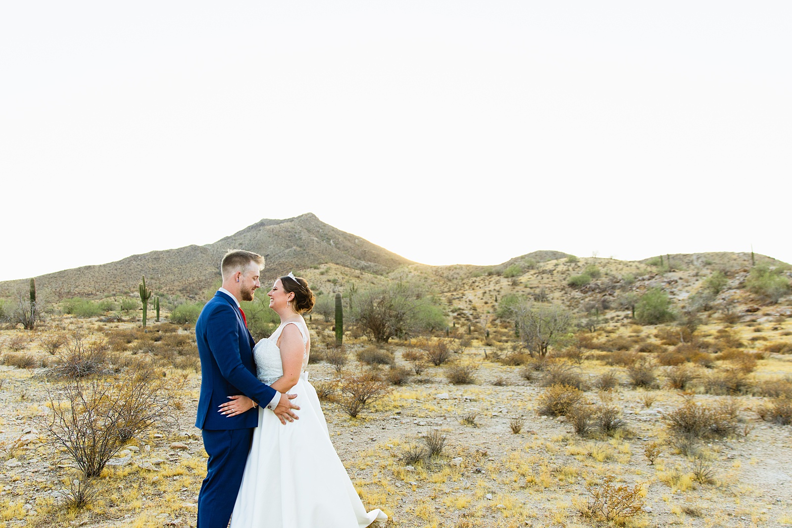 Bride and groom looking at each other during their intimate desert wedding by Phoenix wedding photographer Juniper and Co Photography.