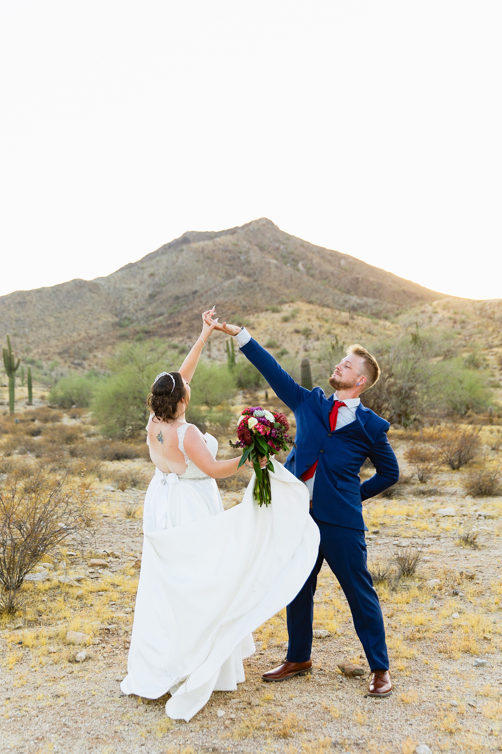 Bride and groom having fun together during their intimate desert wedding by Phoenix wedding photographer Juniper and Co Photography.