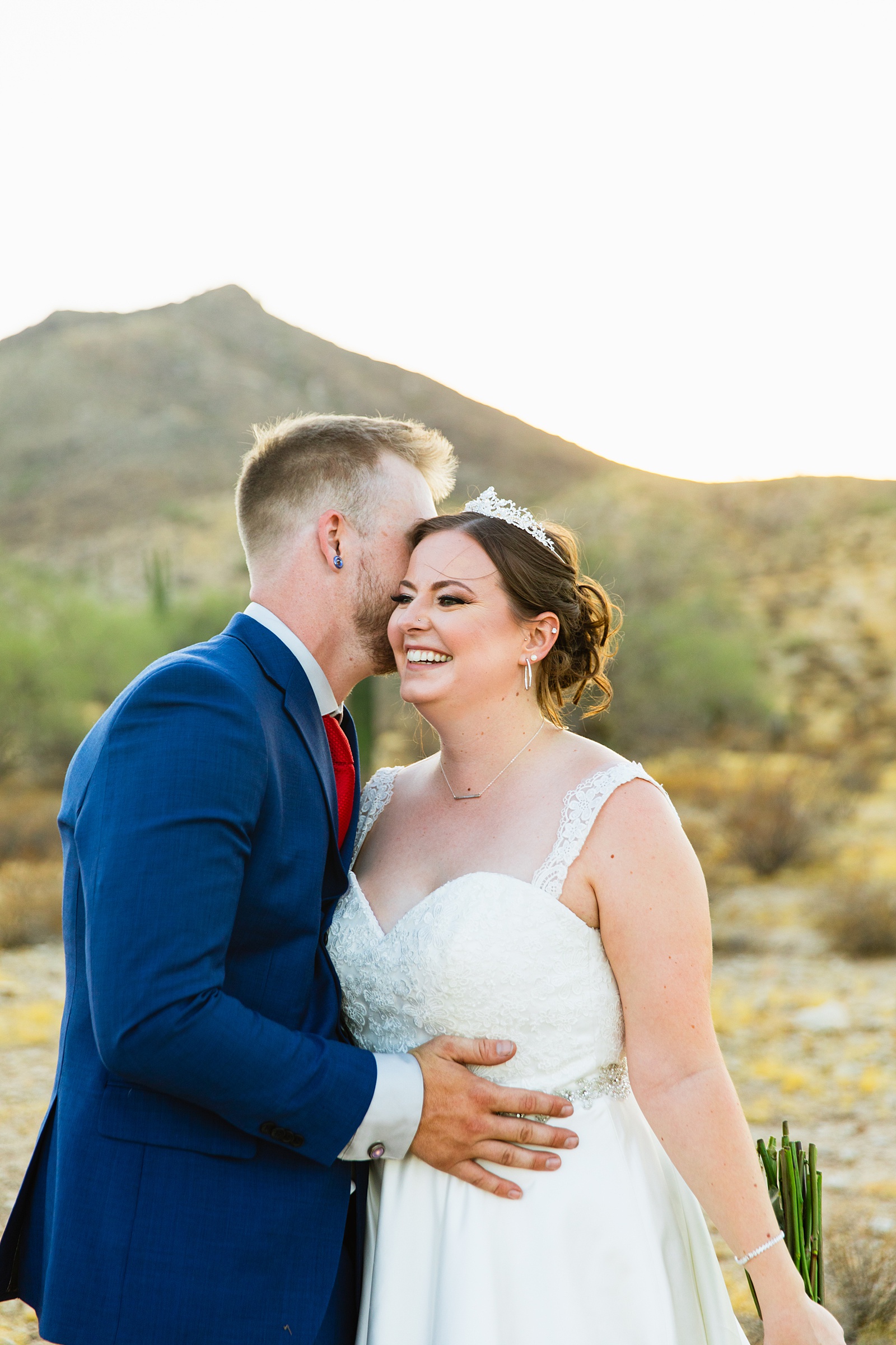 Bride and groom laughing together during their intimate desert wedding by Arizona wedding photographer Juniper and Co Photography.