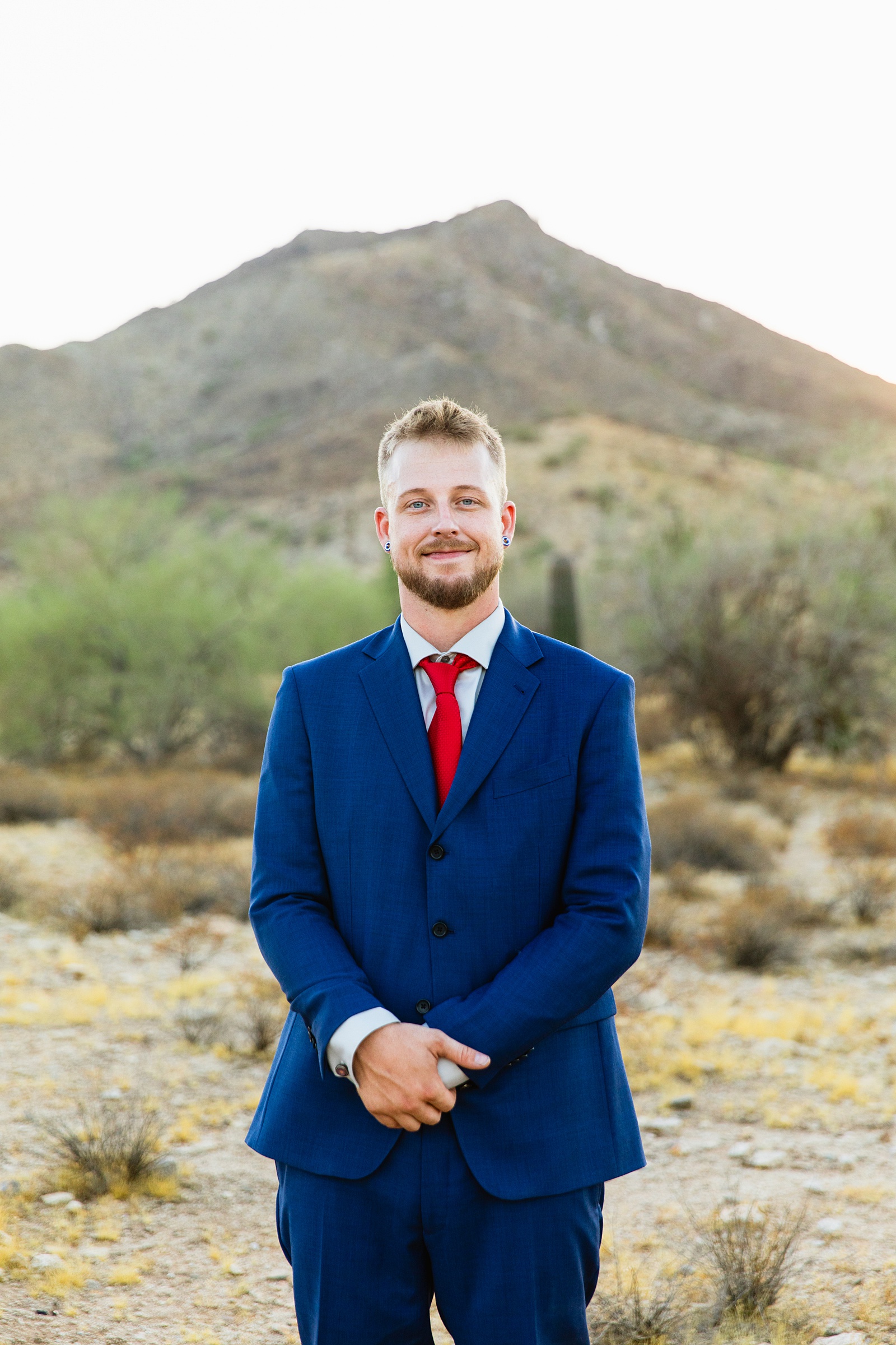 Groom's blue suit for his intimate desert wedding by Juniper and Co Photography.