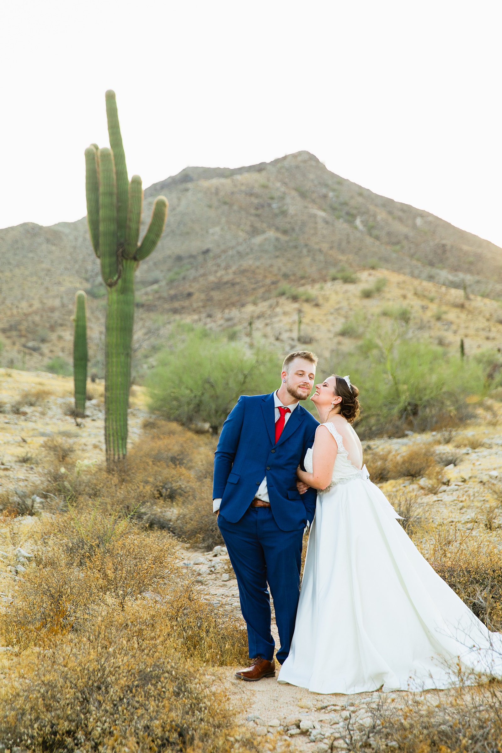 Bride and groom share a kiss during their intimate desert wedding by Arizona wedding photographer Juniper and Co Photography.