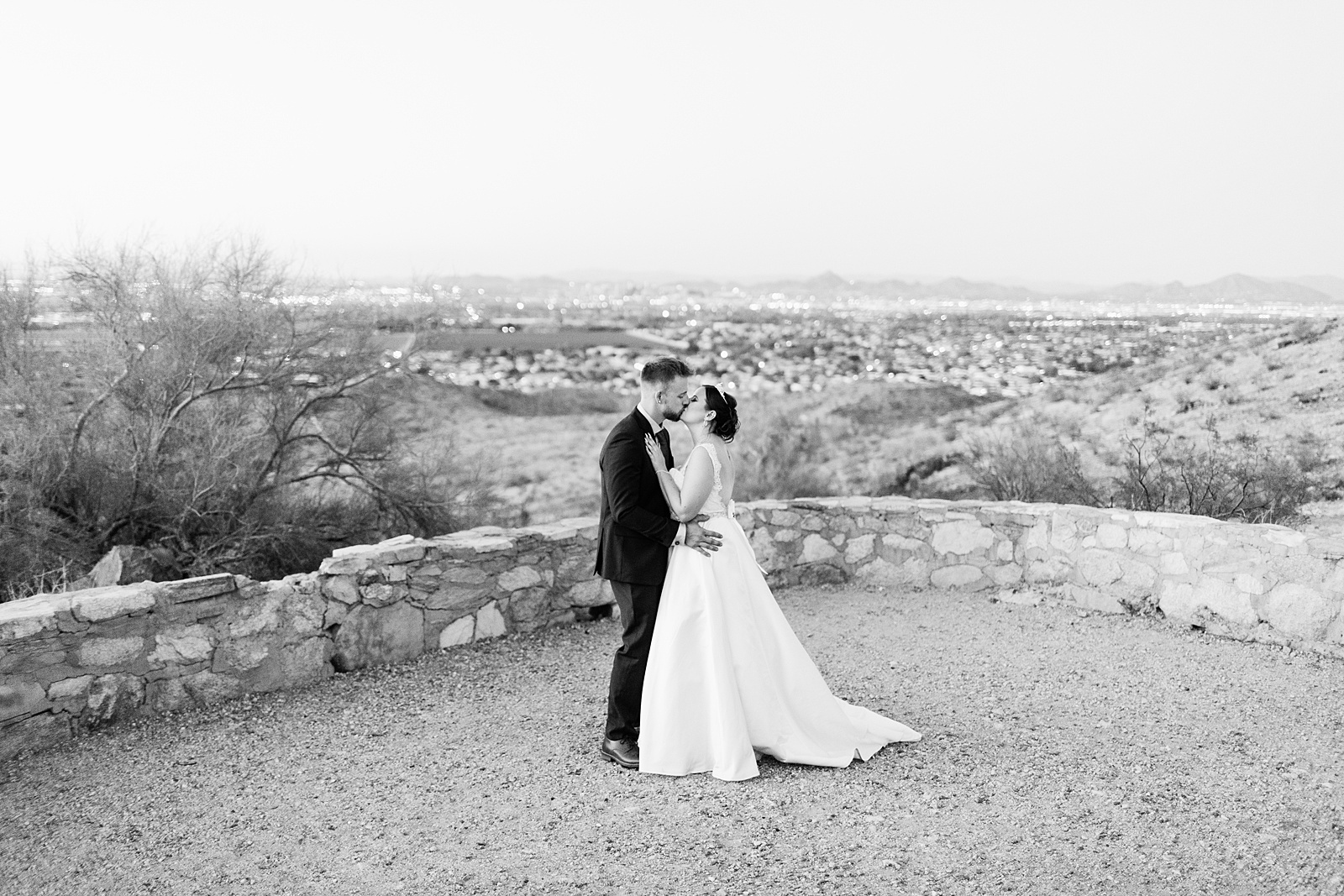 Bride and groom share a kiss during their intimate desert wedding by Arizona wedding photographer Juniper and Co Photography.