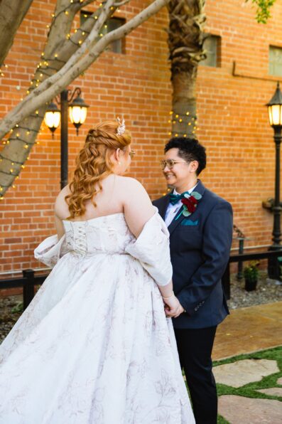 Same sex couple's first look at Regency Garden by Phoenix wedding photographer Juniper and Co Photography.
