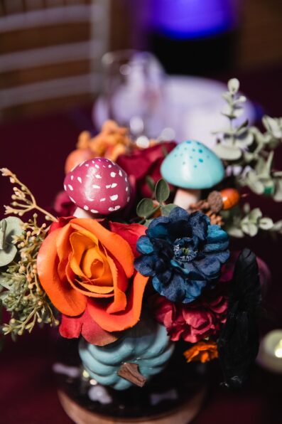 Hand painted woodland mushroom and fairy flowers centerpieces at Regency Garden wedding reception by Mesa wedding photographer Juniper and Co Photography.