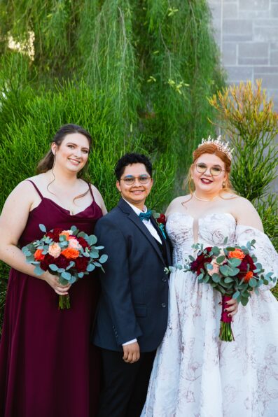 Brides and bridesmaid together at a Regency Garden wedding by Arizona wedding photographer Juniper and Co Photography.