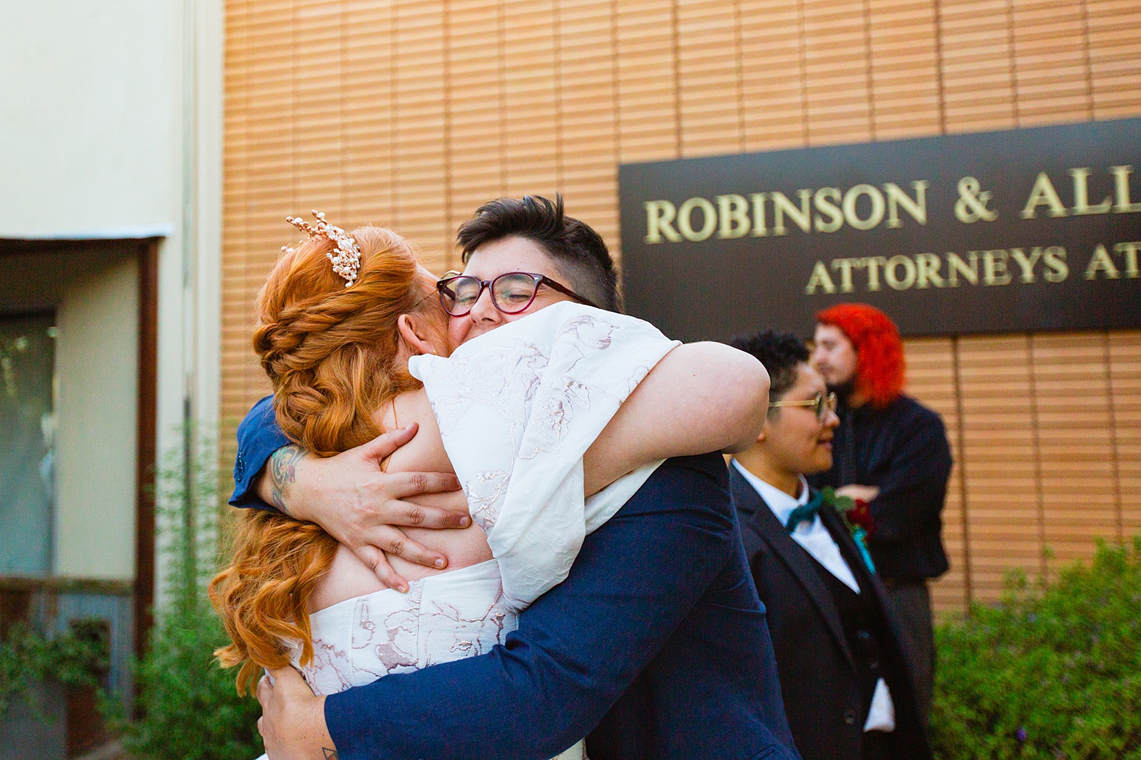 Bride hugging guests at Regency Garden wedding by Mesa wedding photographer Juniper and Co Photography.