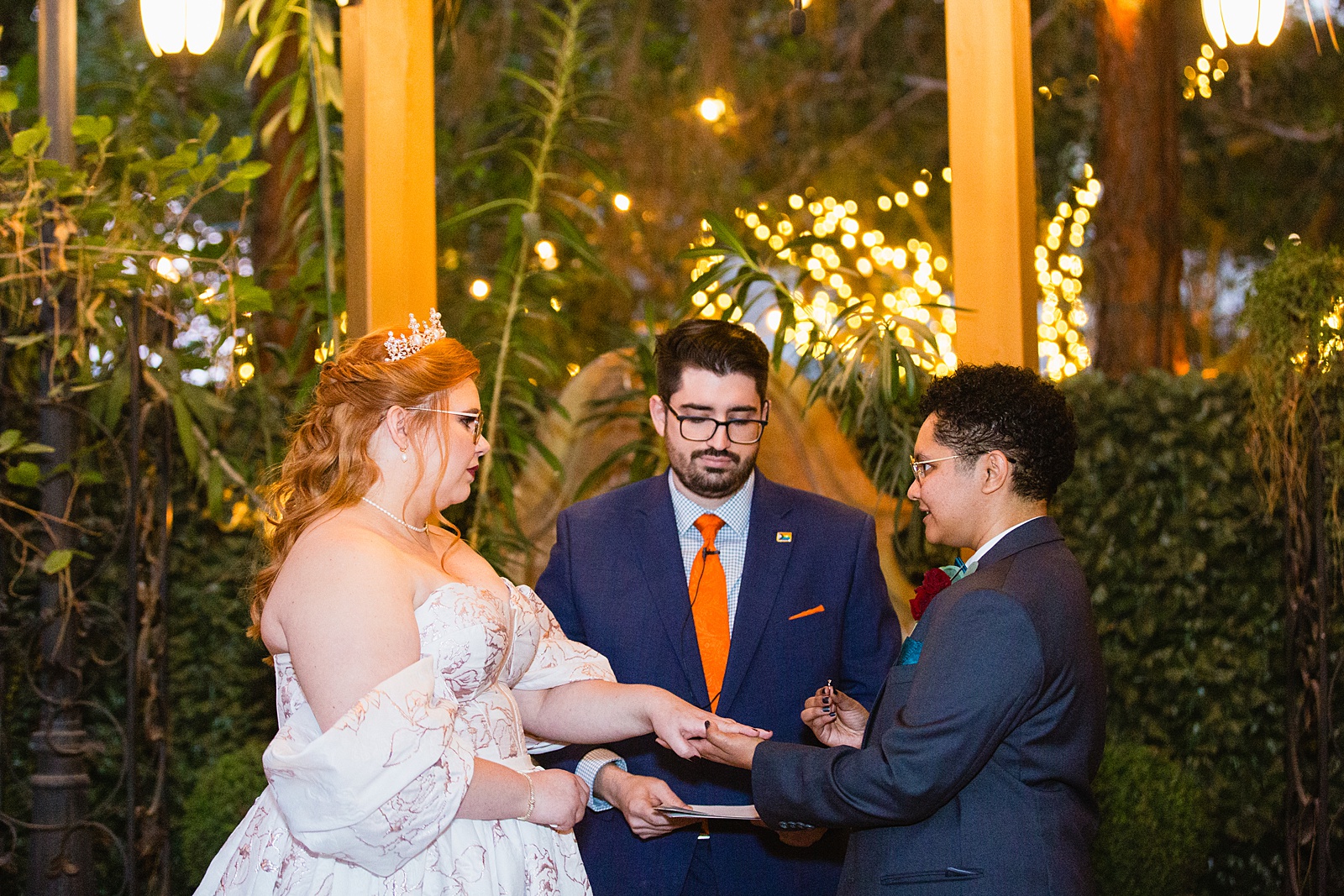 Same sex couple exchange rings during their wedding ceremony at Regency Garden by Phoenix wedding photographer Juniper and Co Photography.