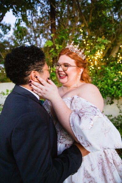 Same sex couple laughing together during their Regency Garden wedding by Arizona wedding photographer Juniper and Co Photography.