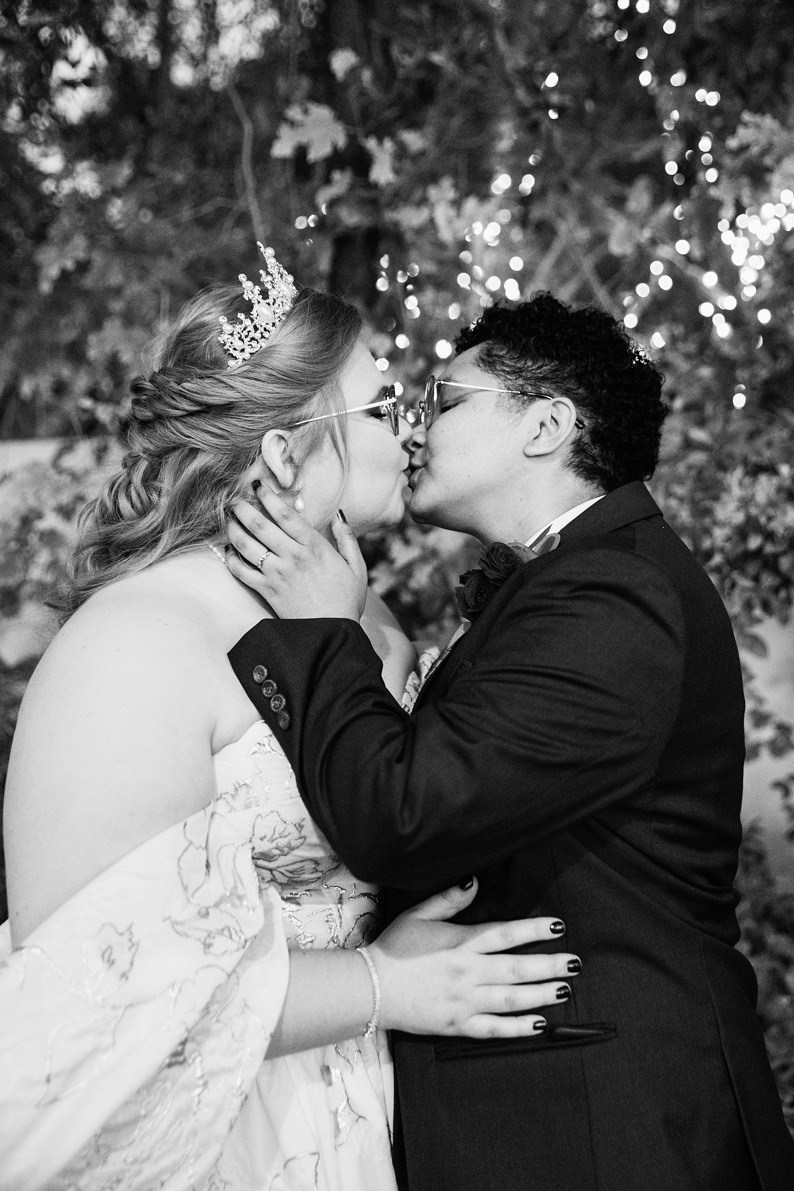 Same sex couple share a kiss during their Regency Garden wedding by Mesa wedding photographer Juniper and Co Photography.