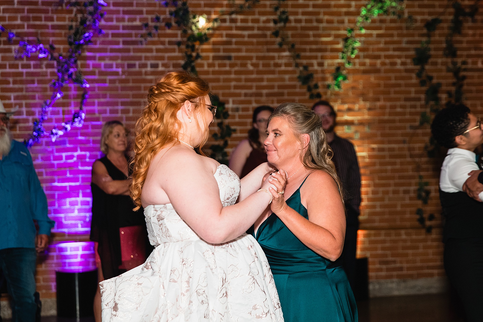 Bride dancing with her mother at Regency Garden wedding reception by Mesa wedding photographer Juniper and Co Photography.