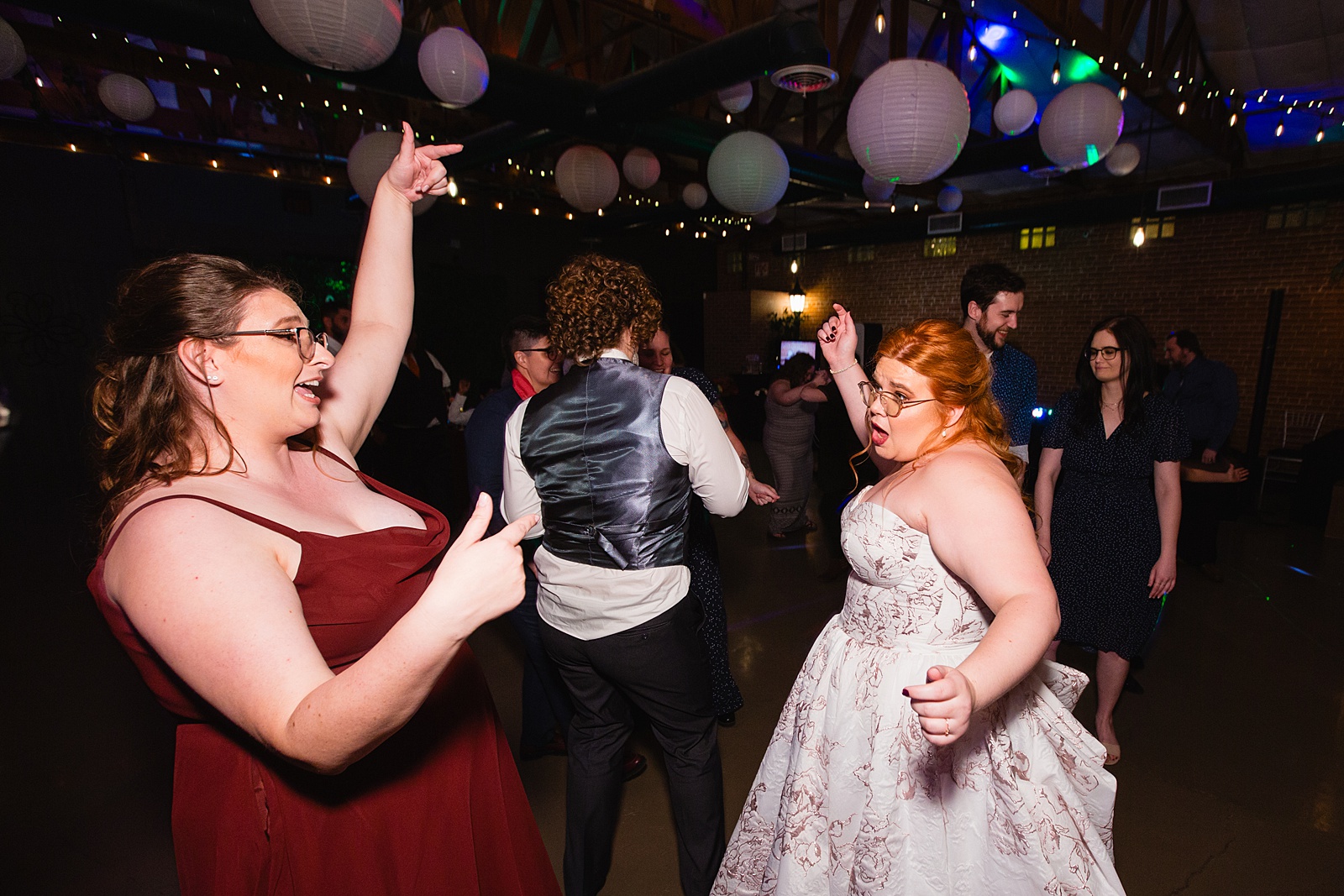 Bride dancing with guests at Regency Garden wedding reception by Mesa wedding photographer Juniper and Co Photography.