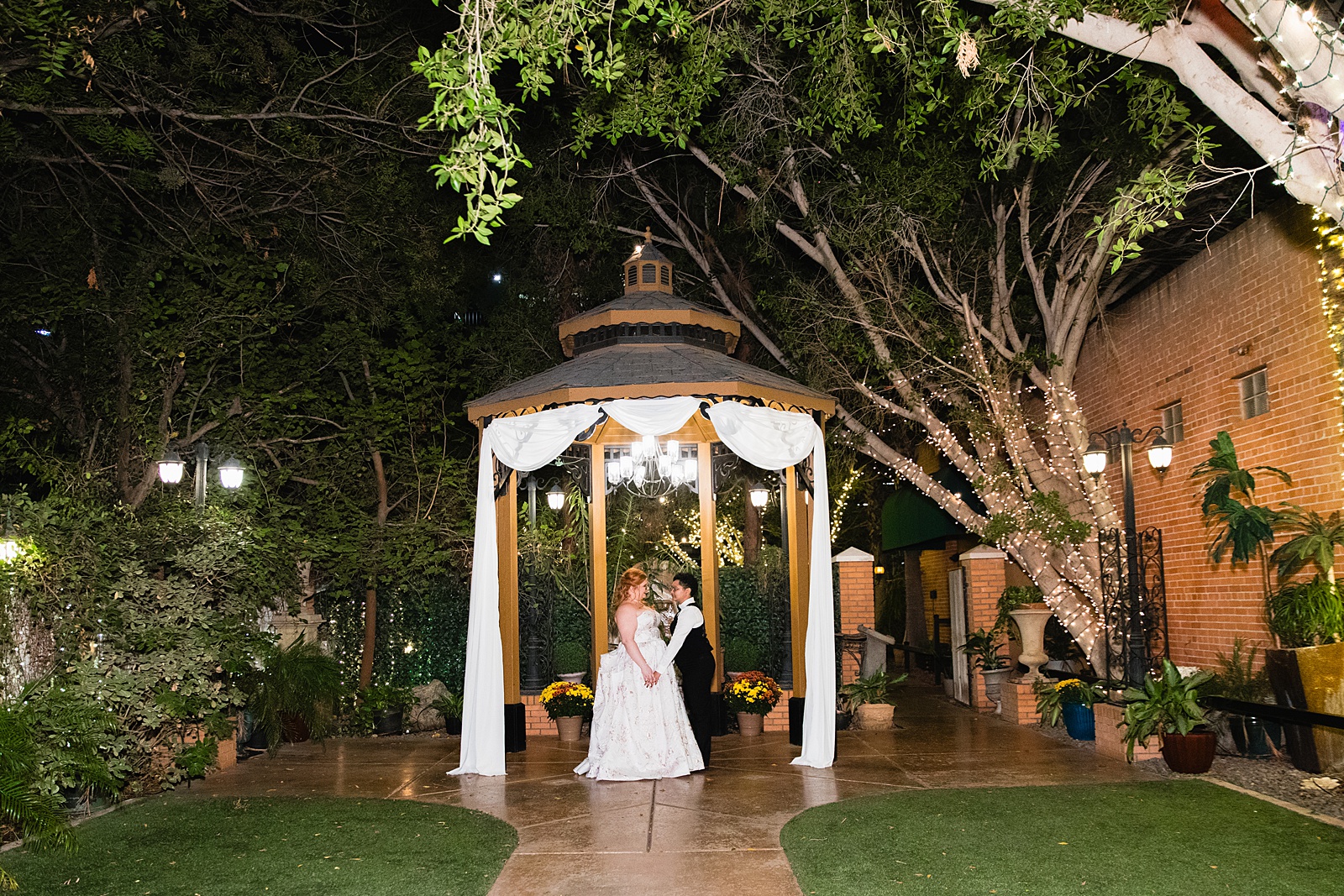 Same sex couple share an intimate moment at their Regency Garden wedding by Arizona wedding photographer Juniper and Co Photography.