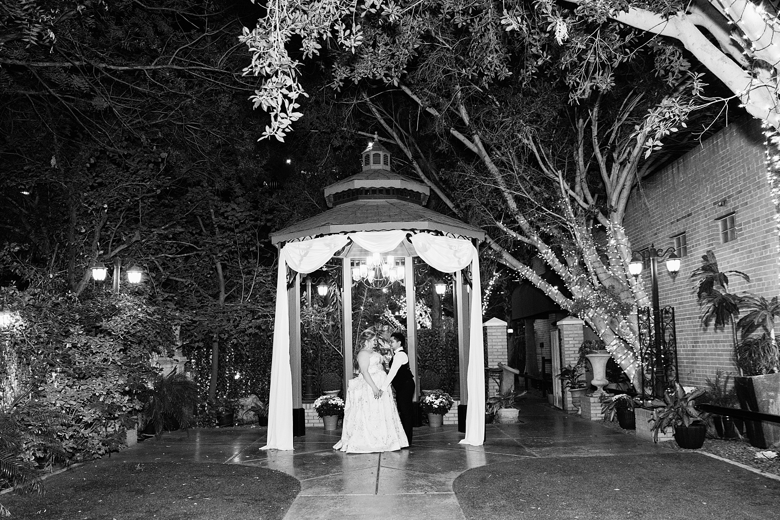 Same sex couple share an intimate moment and end of the night dance at their Regency Garden wedding by Arizona wedding photographer Juniper and Co Photography.