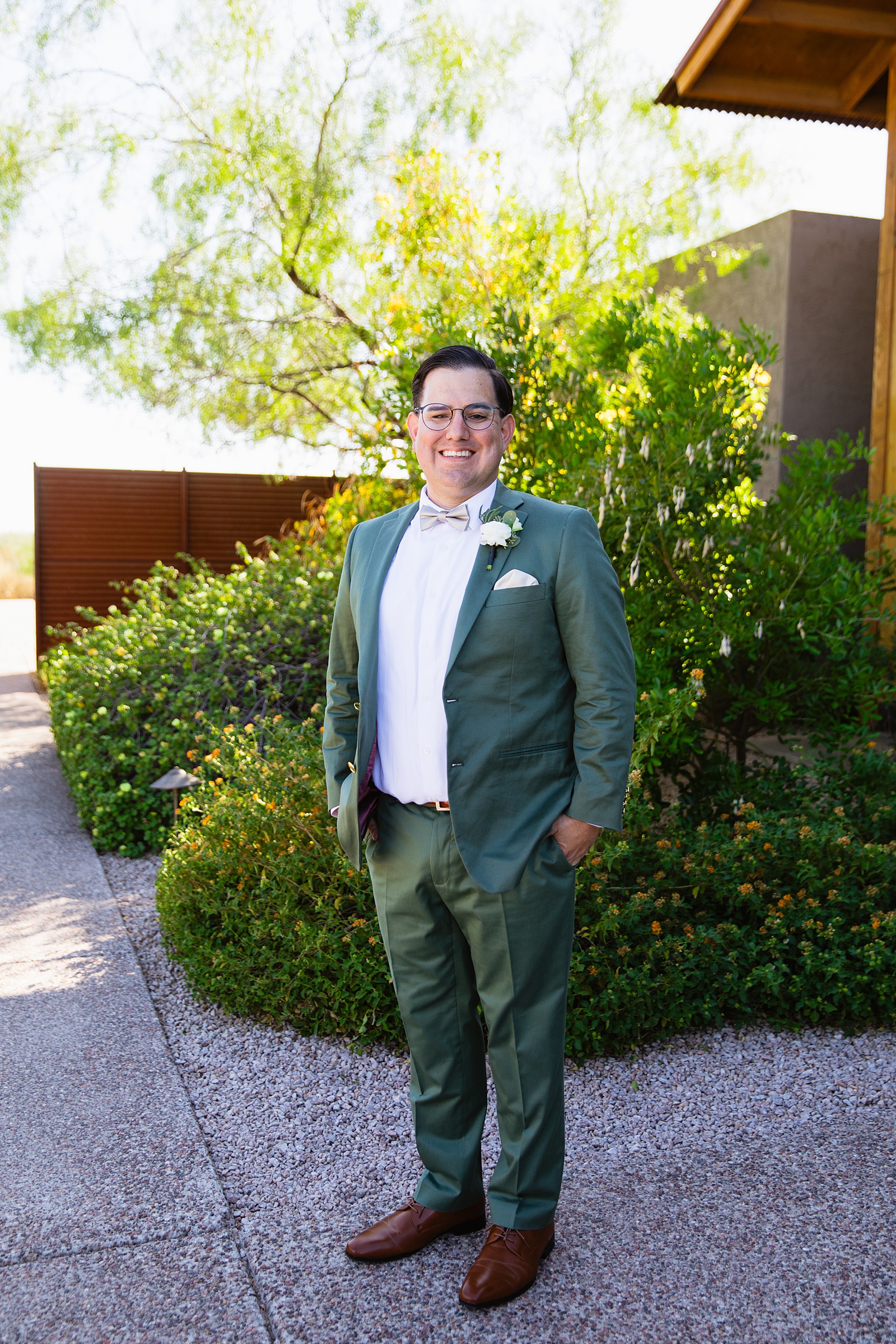 Groom's sage green suit for his Phoenix desert intimate wedding by Juniper and Co Photography.