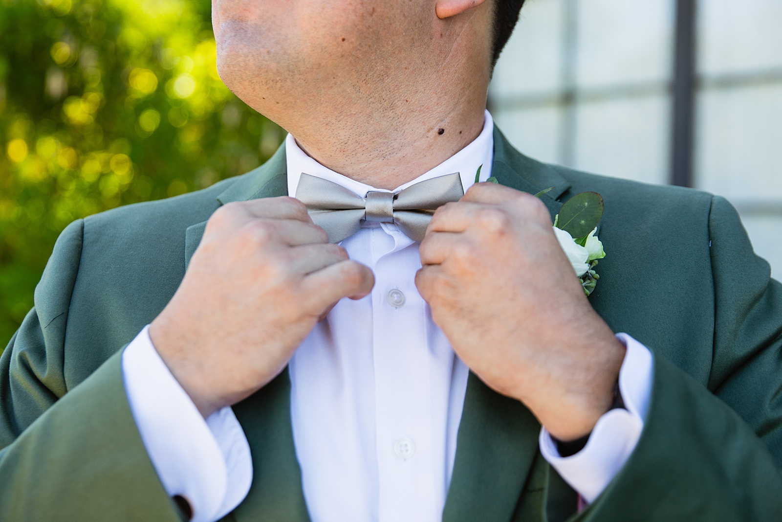 Groom's sage green suit with grey bow tie and boutonniere for his Phoenix desert intimate wedding by Juniper and Co Photography.