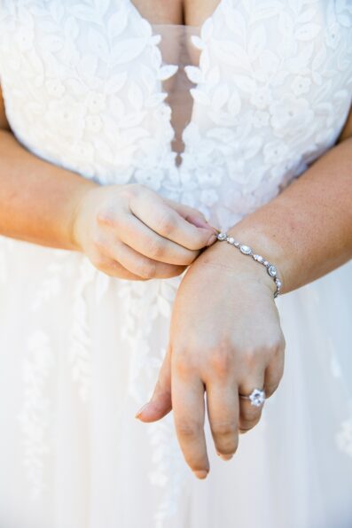 Bride adjusting her bracelet on her wedding day by Phoenix wedding photographers Juniper and Co Photography.