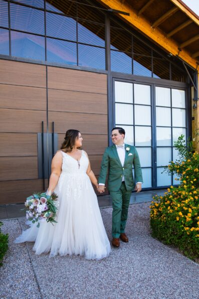 Newlyweds walking together during their Phoenix desert intimate wedding by Arizona wedding photographer Juniper and Co Photography.