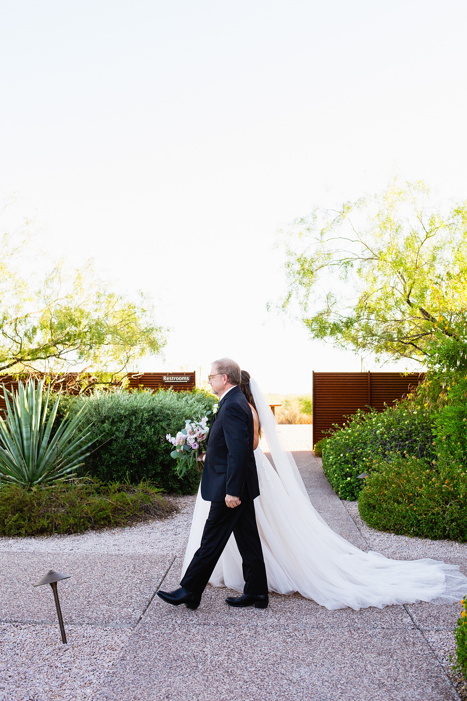 Bride walking down aisle during a Phoenix desert intimate wedding ceremony by Phoenix wedding photographer Juniper and Co Photography.