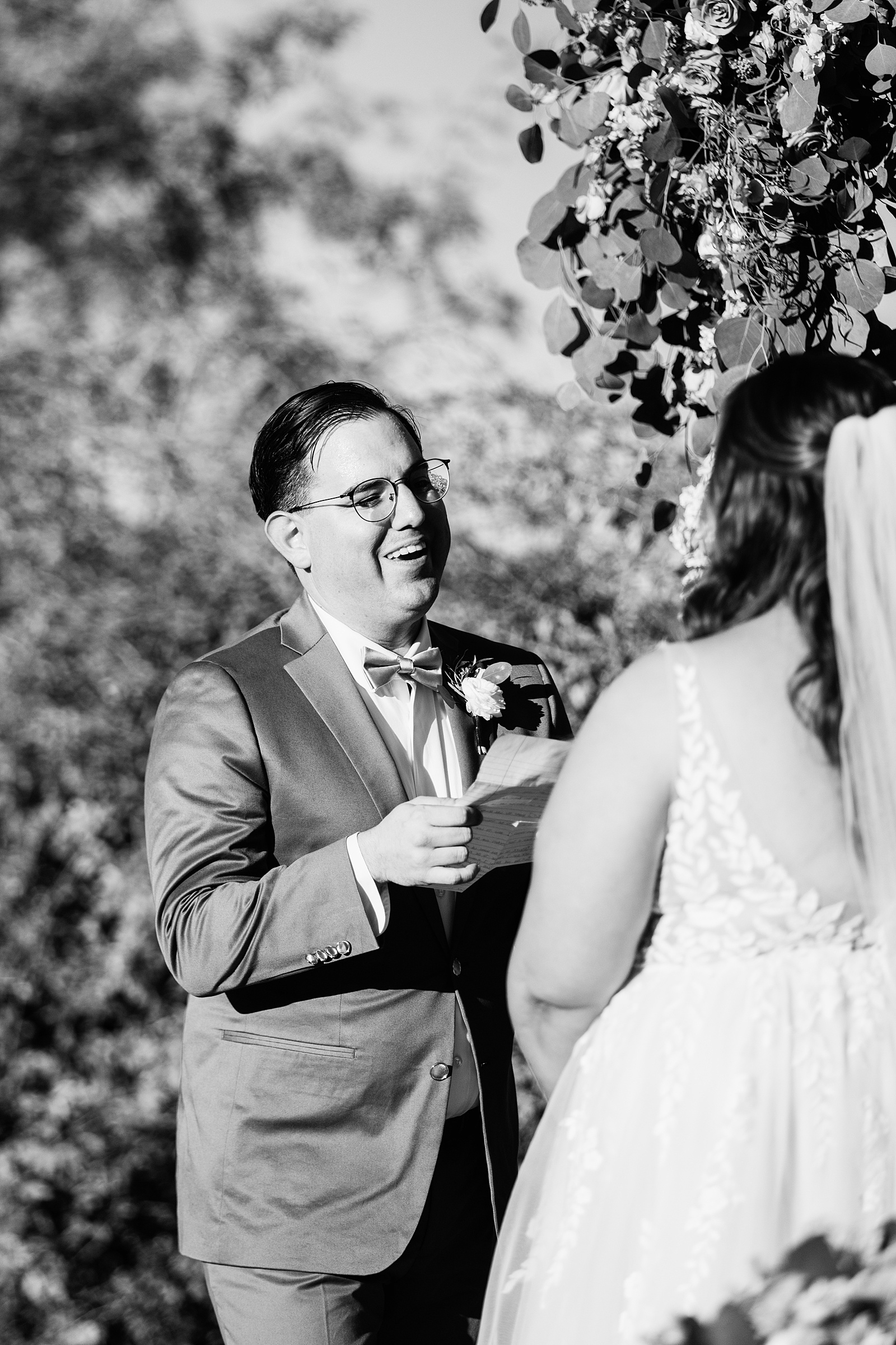 Bride & Groom laughing together during their wedding ceremony at a Phoenix desert intimate wedding by Phoenix wedding photographer Juniper and Co Photography.