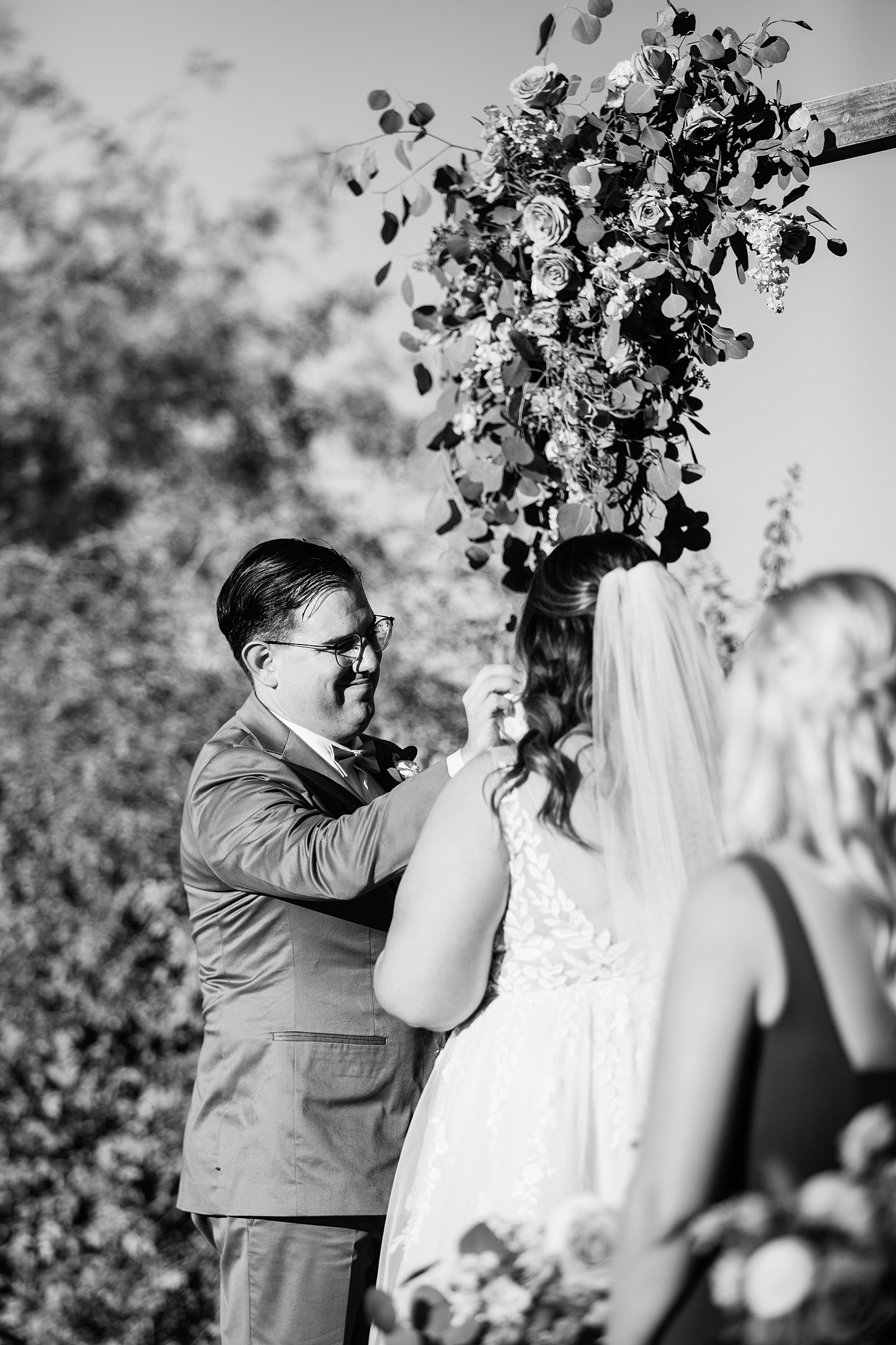 Groom looking at his bride during their wedding ceremony at a Phoenix desert intimate wedding by Phoenix wedding photographer Juniper and Co Photography.