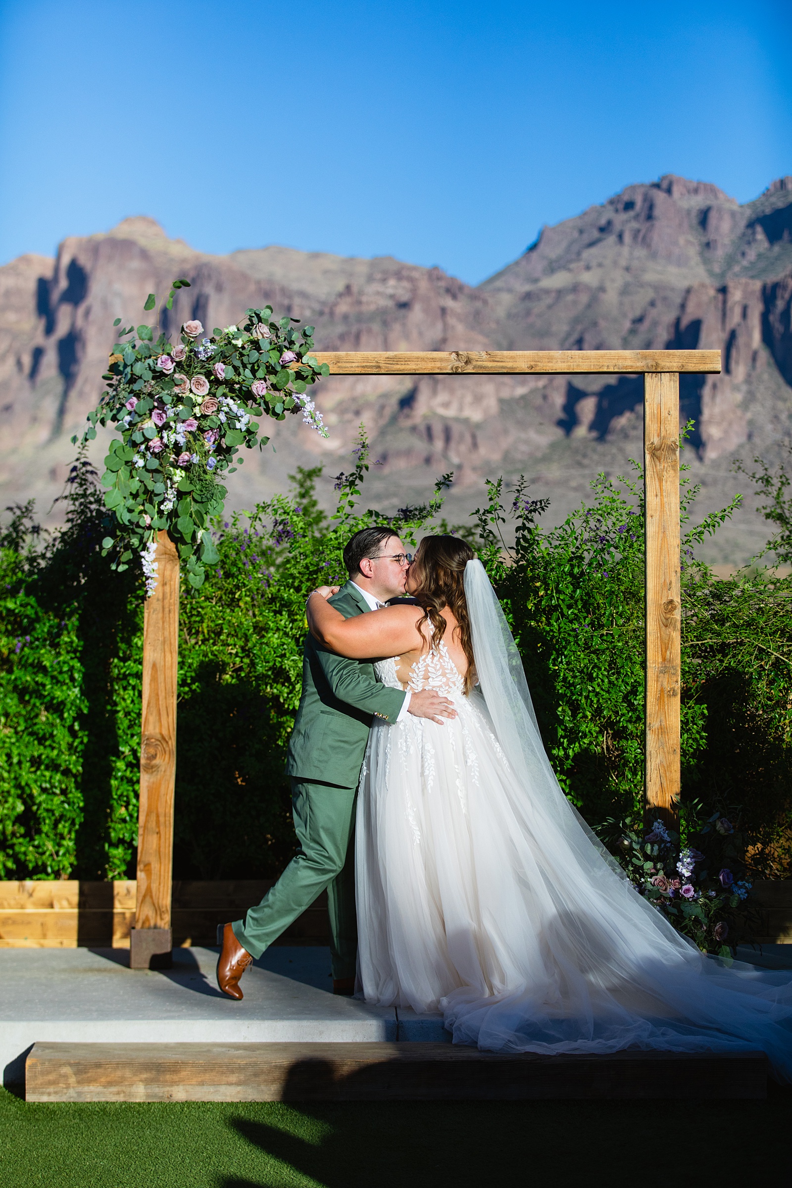 Bride & Groom share their first kiss during their wedding ceremony at a Phoenix desert intimate wedding by Arizona wedding photographer Juniper and Co Photography.