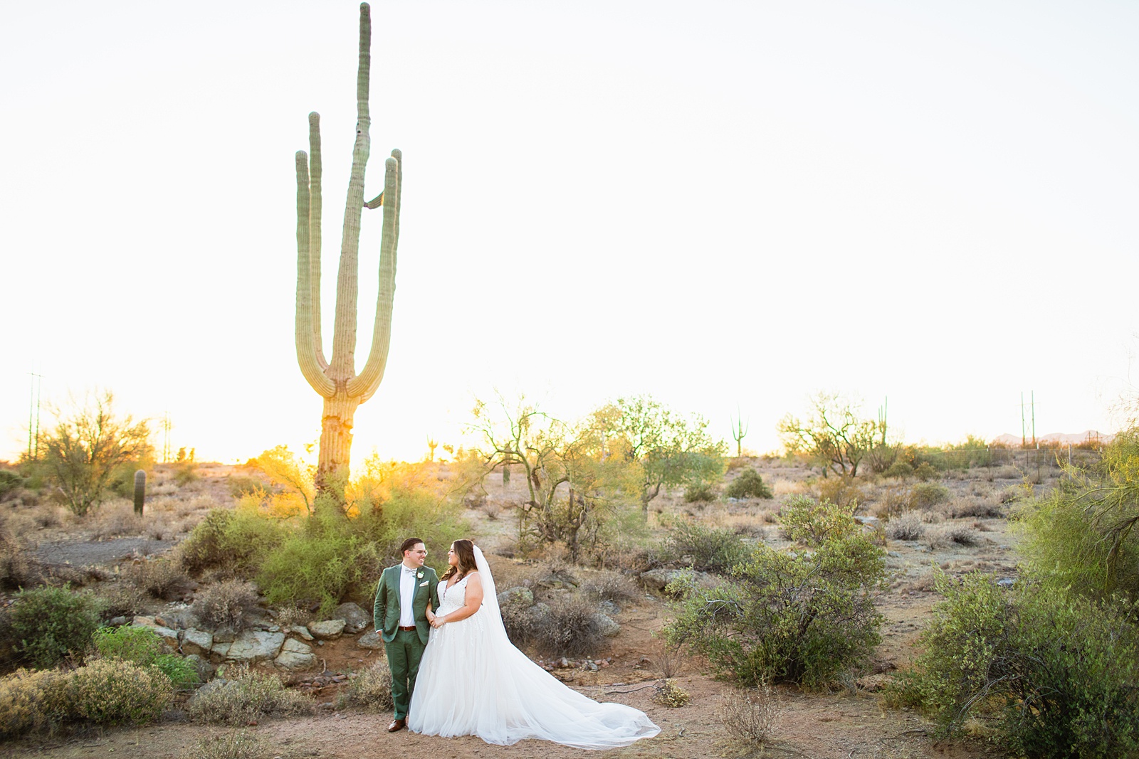 Bride & Groom looking at each other during their a Phoenix desert intimate wedding by Phoenix wedding photographer Juniper and Co Photography.