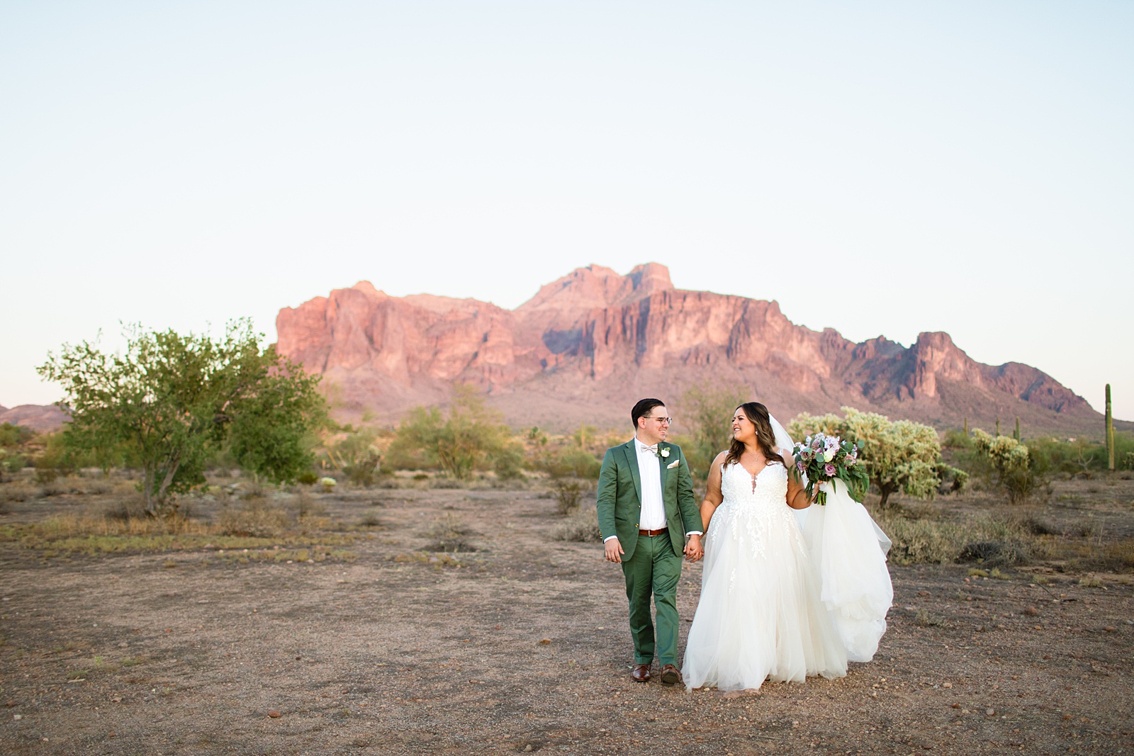 Bride & Groom walking together during their a Phoenix desert intimate wedding by Phoenix wedding photographer Juniper and Co Photography.