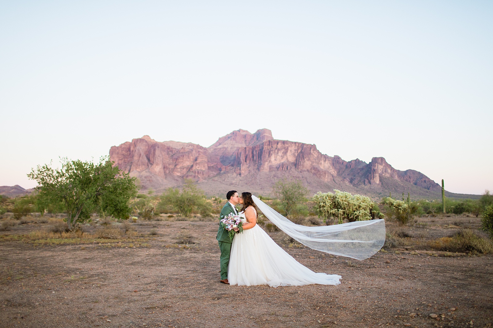 Bride & Groom share a kiss during their a Phoenix desert intimate wedding by Arizona wedding photographer Juniper and Co Photography.