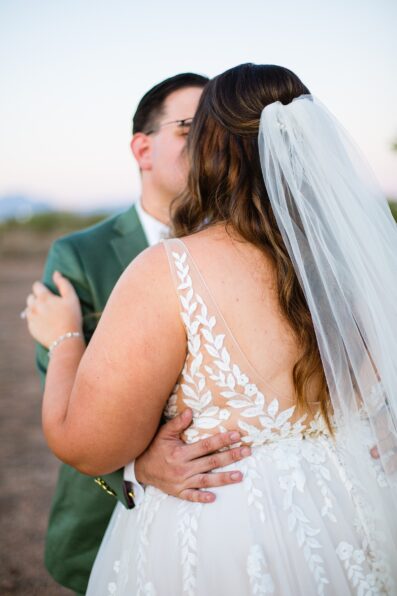 Bride & Groom share a kiss during their a Phoenix desert intimate wedding by Phoenix wedding photographer Juniper and Co Photography.