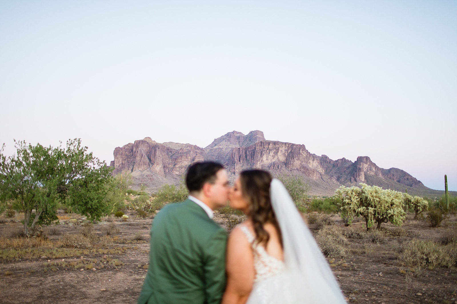 Bride & Groom share a kiss during their a Phoenix desert intimate wedding by Phoenix wedding photographer Juniper and Co Photography.
