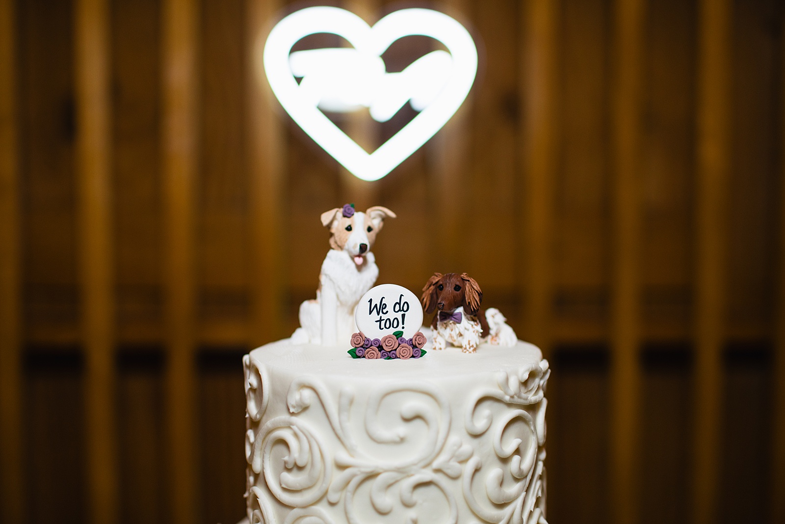 Puppy dog cake topper on white wedding cake by Arizona wedding photographer Juniper and Co Photography.