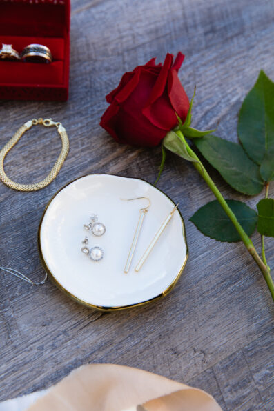 Couple's wedding day details of rings and jewelry by Juniper and Co Photography.