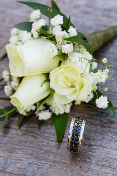Couple's wedding day details of rings and flowers by Juniper and Co Photography.