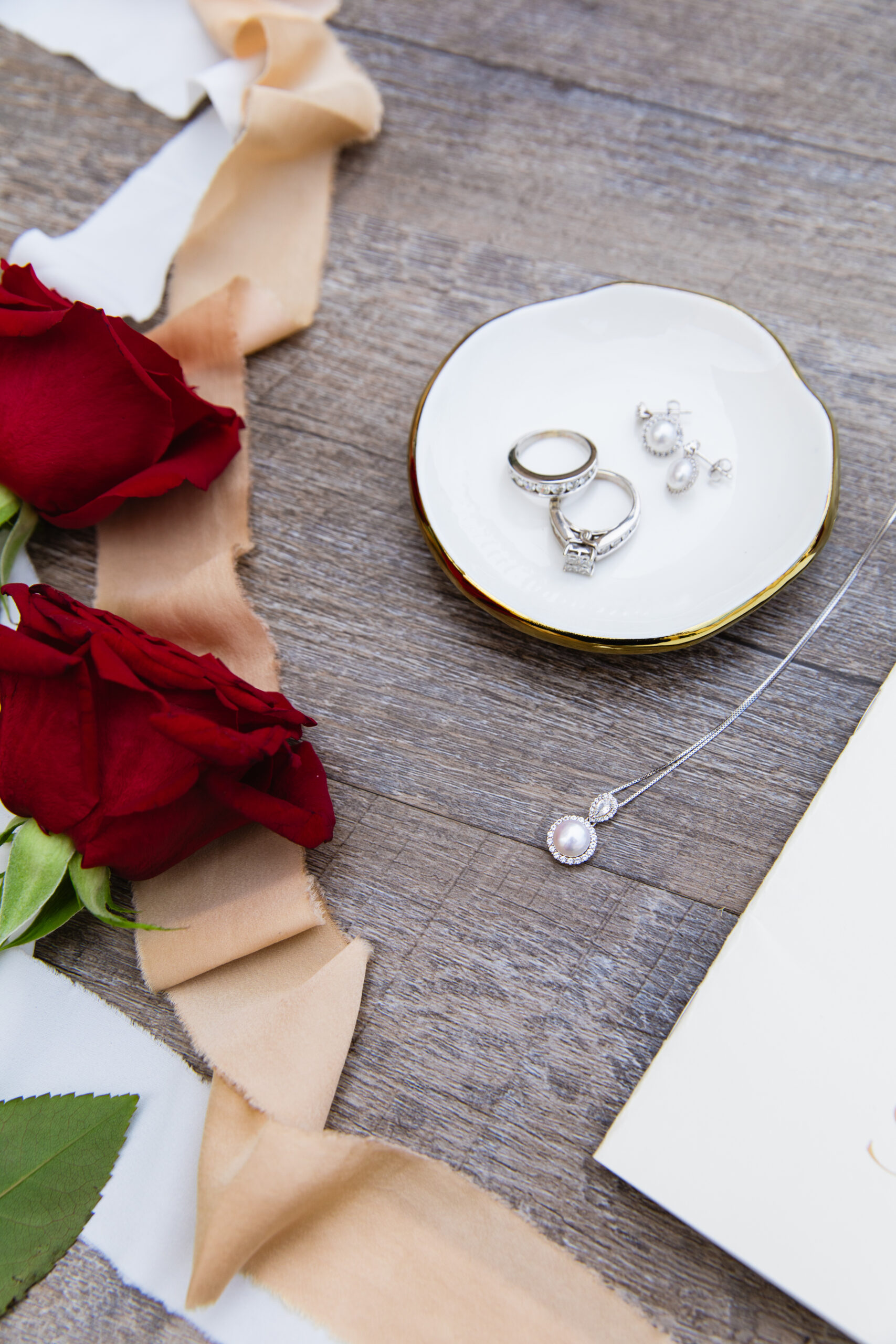 Couple's wedding day details of rings and jewelry by Juniper and Co Photography.