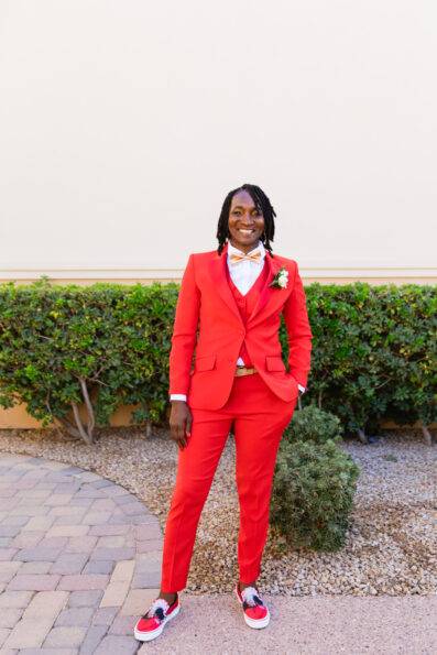 Bride's all red suit for her intimate desert wedding by Juniper and Co Photography.