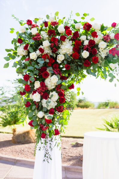 Wedding ceremony floral arch at intimate desert by Phoenix wedding photographer Juniper and Co Photography.