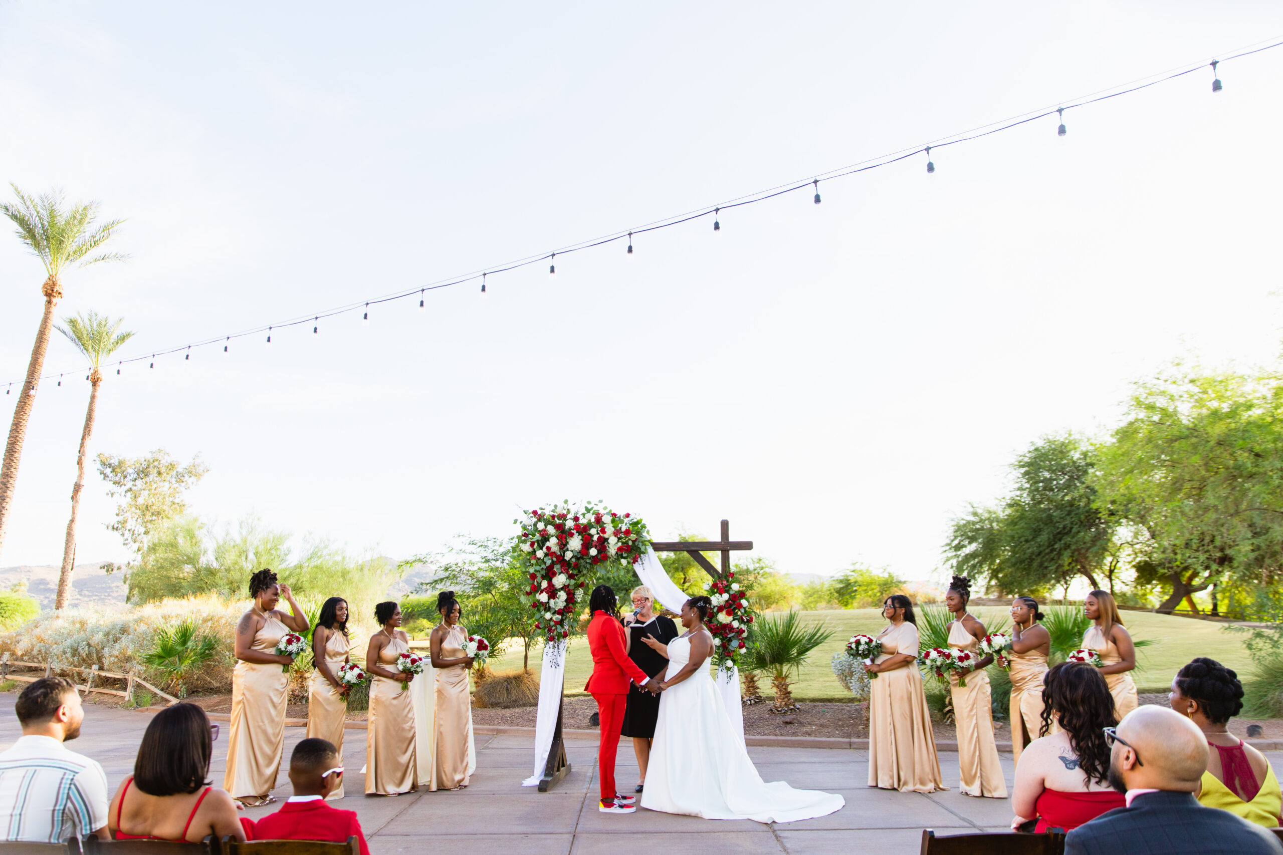 Bride and bride exchange vows during their intimate desert wedding ceremony by Phoenix wedding photographer Juniper and Co Photography.