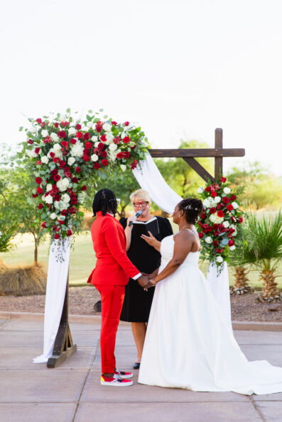 Bride and bride exchange vows during their intimate desert wedding ceremony by Phoenix wedding photographer Juniper and Co Photography.